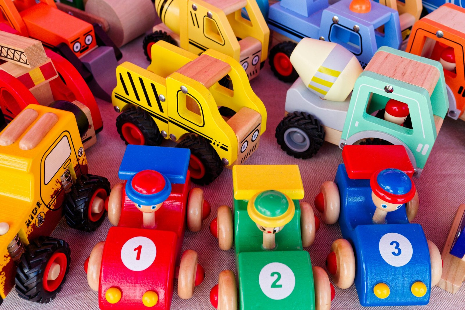 A pile of toy cars sitting on top of a table